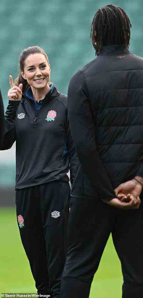 Kate flashes a smile as she chats to members of the men's squad