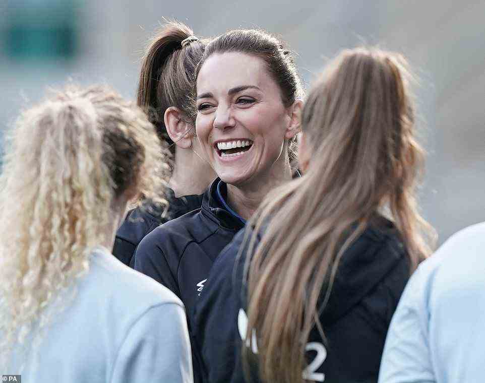 Beaming Kate couldn't keep the smile from her face as she took to the pitch ahead of the training session today