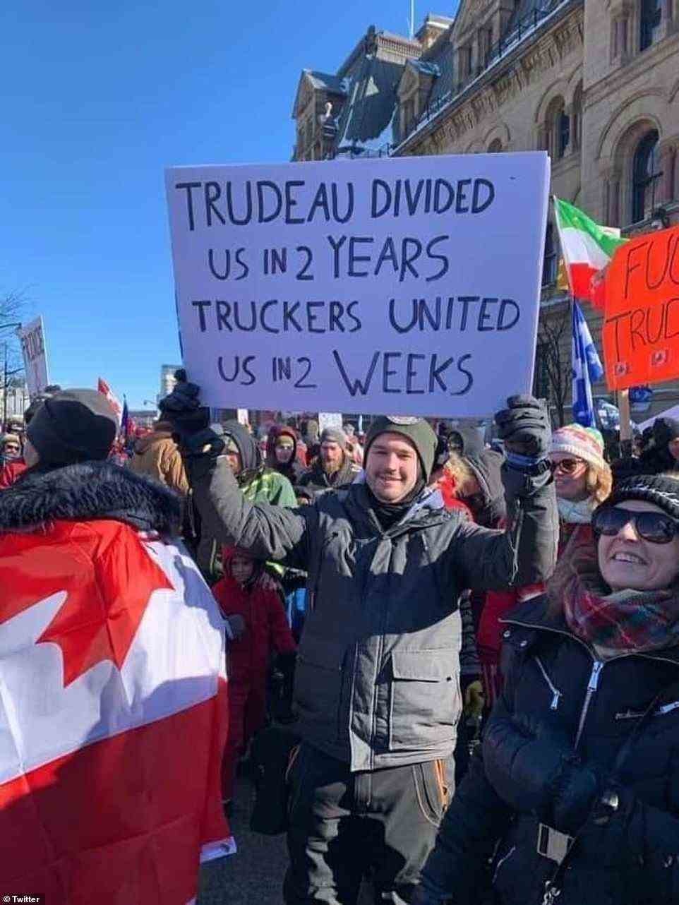 One man holds up a sign arguing how the truckers have 'united' the country