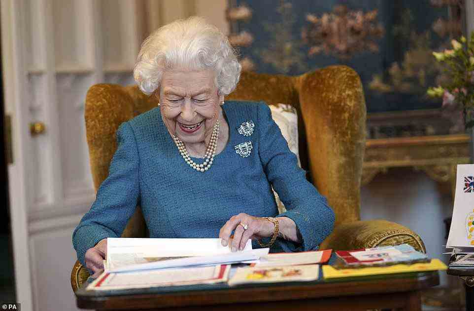 Photographs have been released of Her Majesty looking at her Platinum Jubilee cards and memorabilia from the Golden Jubilee in the Oak Room at Windsor Castle