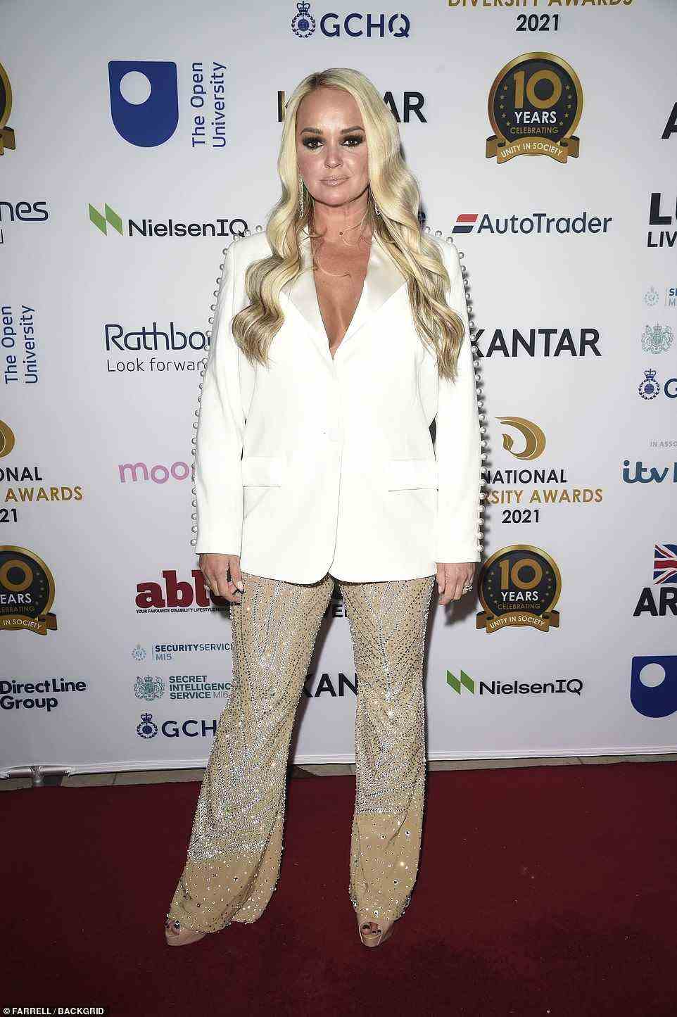 Blonde bombshell: Jennifer Ellison put on a busty display in a white blazer, which she paired with glittery nude trousers
