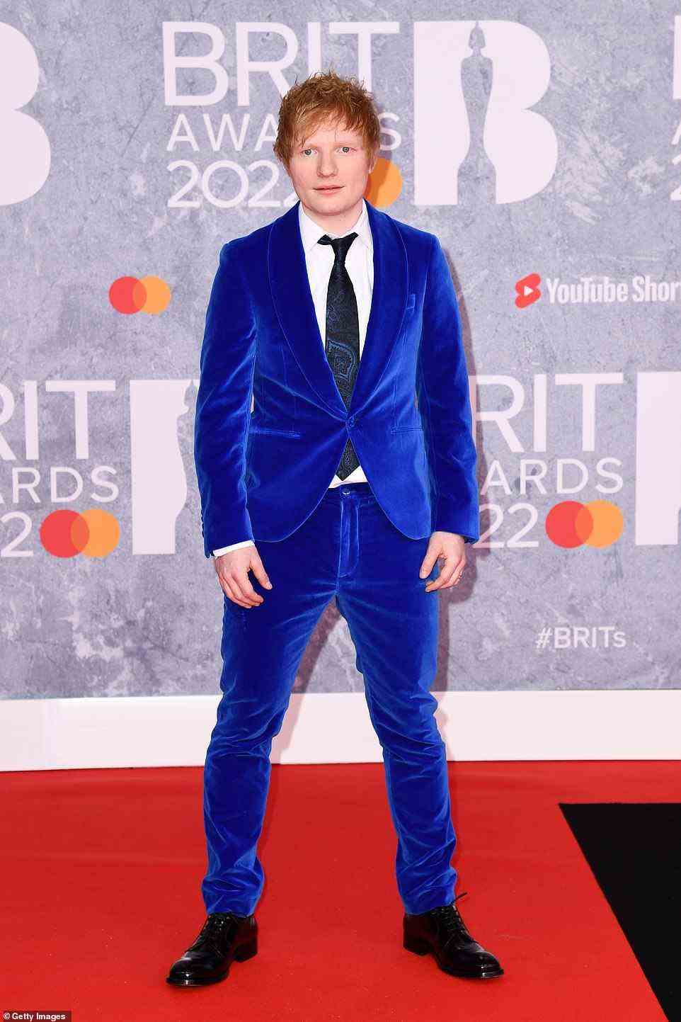 Legend: Ed Sheeran caught the eye in a bright blue velvet suit teamed with a white shirt and black tie as he arrived at the event