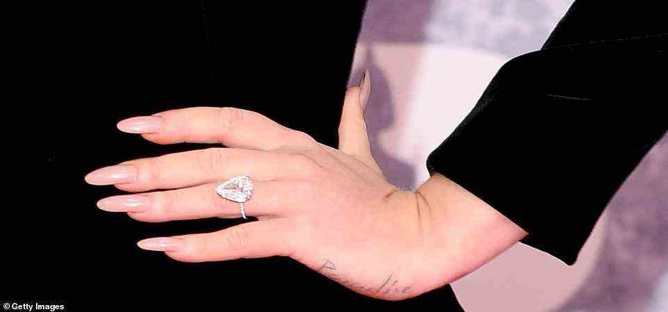 Engaged? Adele - who is a relationship with sports agent Rich Paul - sported a huge diamond ring on her left hand as she posed on the red carpet