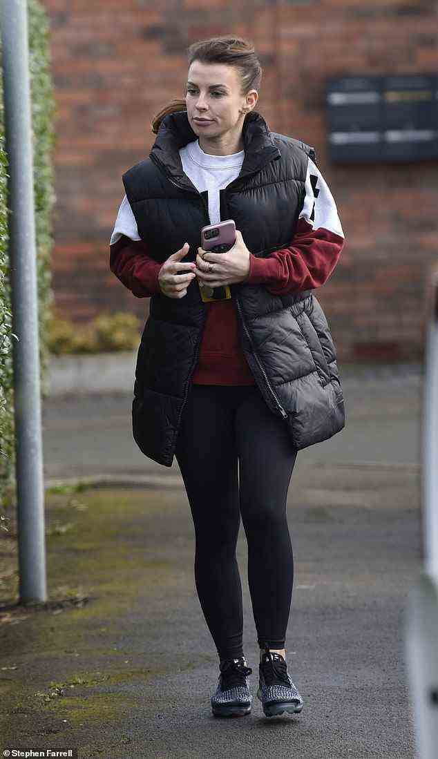 Gym look: Coleen teamed this with black leggings and black and grey trainers, while her brunette locks were swept into a high ponytail which swung about as she walked