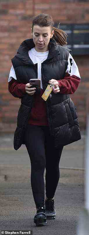 Low-key style: The mother-of-four kept warm in a black padded gilet warm over a white and burgundy colour block sweater