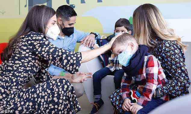 Letizia chatted with a family during her visit to the Proton Therapy Center of the Madrid University Hospital in Pozuelo de Alarcon