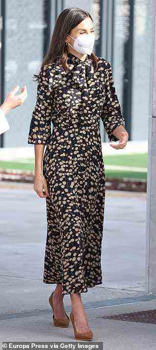The picture of elegance, Letizia opted for a black batwing midi-dress, decorated with a stunning floral pattern