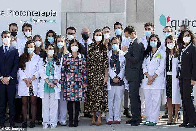 During her visit to the centre, Letizia posed outside the centre with medics and staff of the Proton Therapy Center at the Quironsalud Hospital