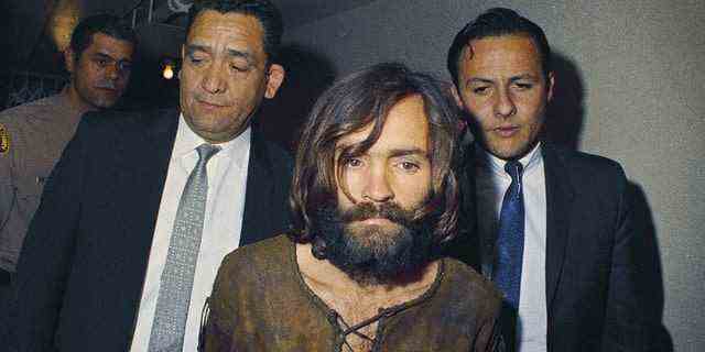 Charles Manson wird 1969 zu seiner Anklage wegen Verschwörung und Mordes eskortiert.