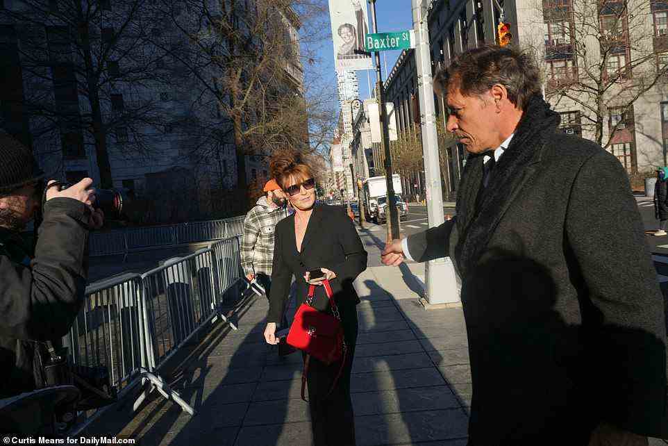 Palin and Ron Duguay reach out to hold hands outside the Federal Court