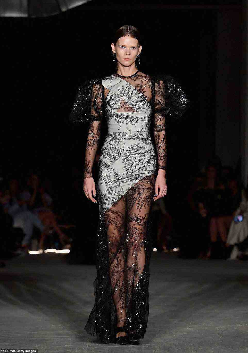 Delicate: Another model rocked a beautiful transparent sequin gown with puffy sleeves