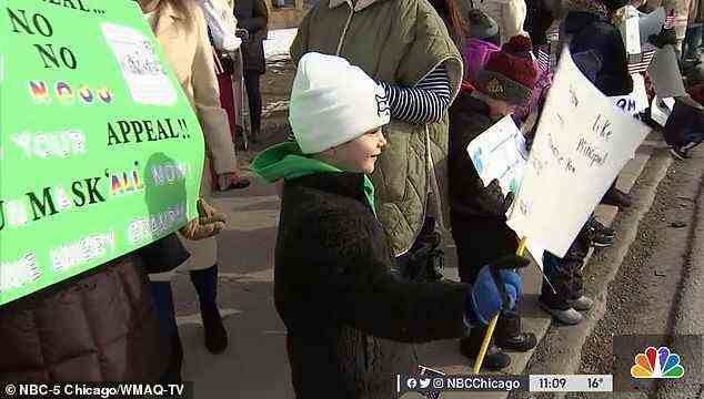 Even little ones helped wave their signs and banners as the community demanded the return of their teacher