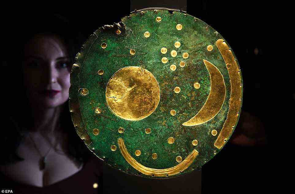 The world's oldest surviving map of the sky and a 'talismanic' chalk drum have gone on display as part of a major new exhibition. Pictured: The 3,600-year-old Nebra Sky Disc, which is going on display at the British Museum