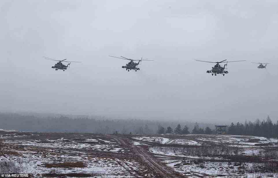Helicopters fly in formation over the Osipovichsky training ground, in central Belarus, today during joint training exercises between Russian and Belarusian forces