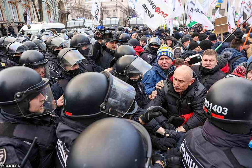 Protesters clash with police in central Kiev today, as part of a march of small business owners to demand extra support as the economy suffers amidst the threat of war