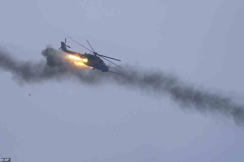 A military helicopter fires flying over the Osipovichi training ground during joint training exercises with Belarus on Thursday
