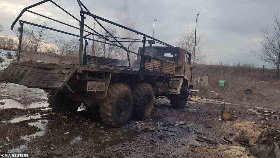 A burned-out military truck is seen on the Ukrainian side of frontlines with Russia rebel forces in the country's east, as Kiev says it was hit by artillery fired by separatists