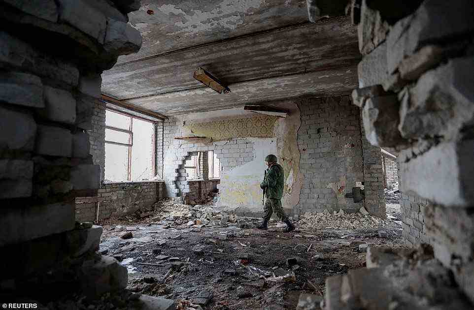 Russian-backed rebel troops inspect damaged buildings near the frontlines with Ukrainian troops, as conflict monitors say there has been a dramatic uptick in clashes in the last 24 hours