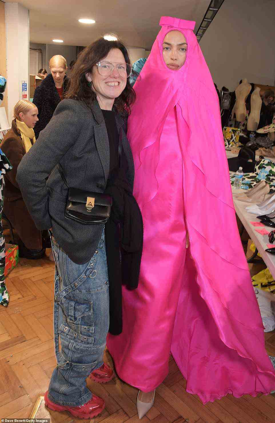 Happy: She was seen posing backstage with Katie Grand in the colourful outfit ahead of taking to the runway