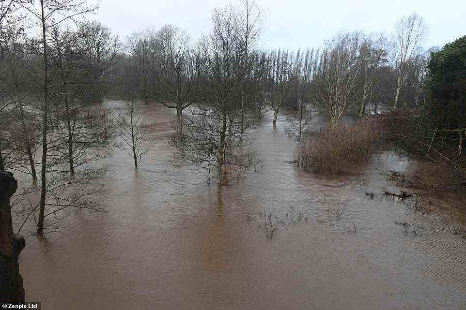 Flooding in a park at Didsbury in Greater Manchester this morning as more than 450 flood alerts or warnings remain in place
