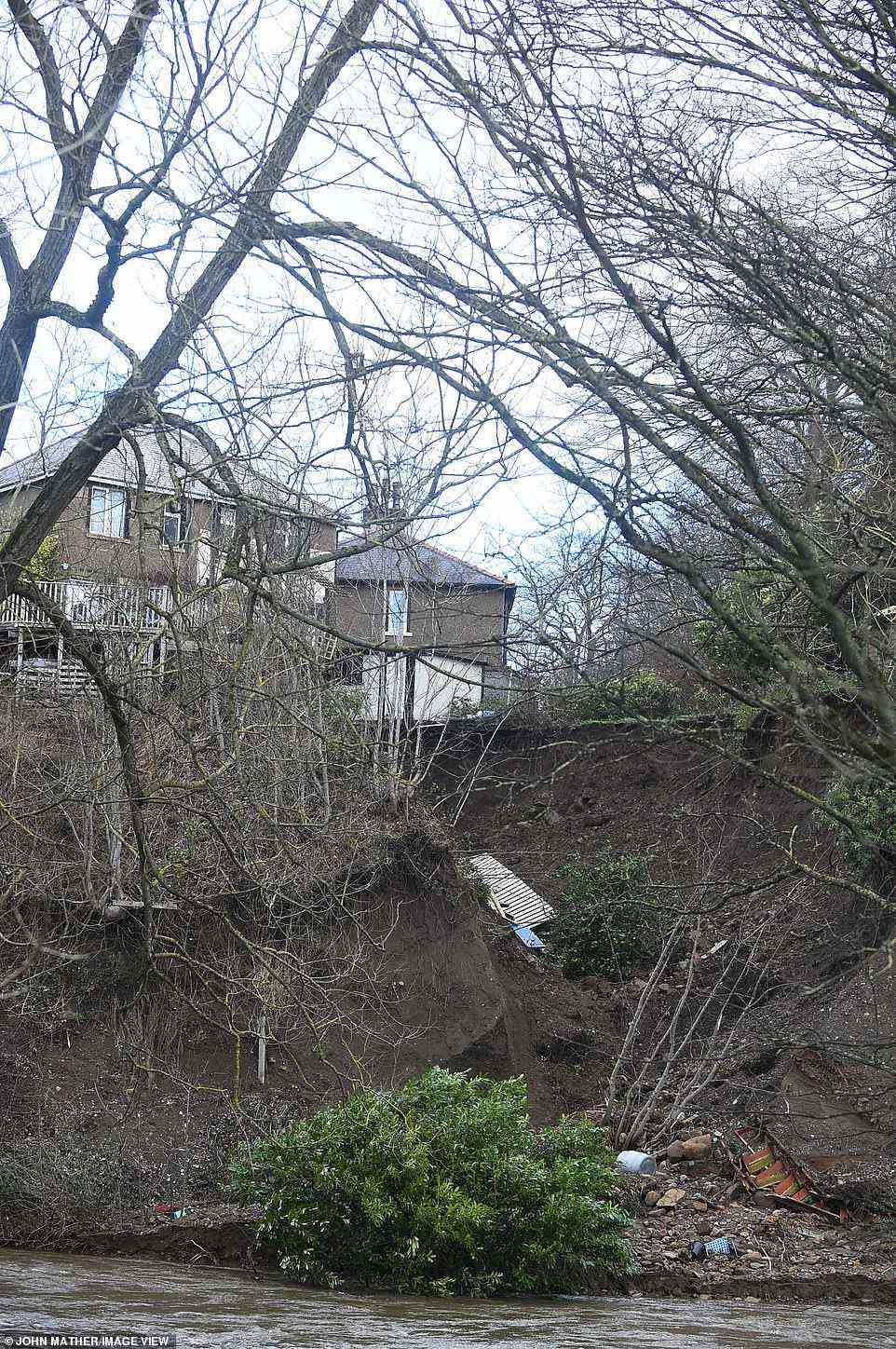 A landslip behind a house in Keighley, West Yorkshire, has taken away the garden and part of the property into a river below