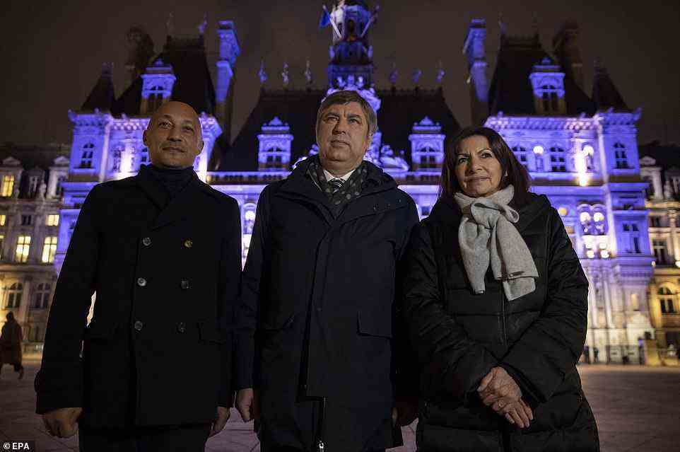 Mayor of Paris Anne Hidalgo (right), deputy mayor of Paris Arnaud Ngatcha (left) and Ukrainian ambassador to France Vadym Omelchenko pose in front of Paris Town Hall