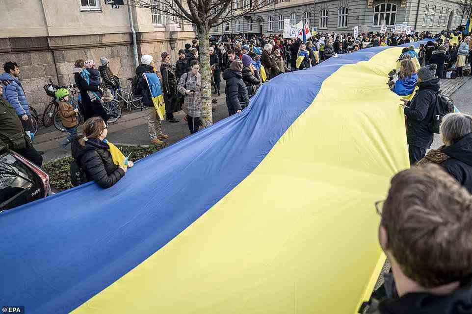 In Copenhagen, scores held an enormous Ukrainian flag aloft as others massed with banners in front of the Russian embassy