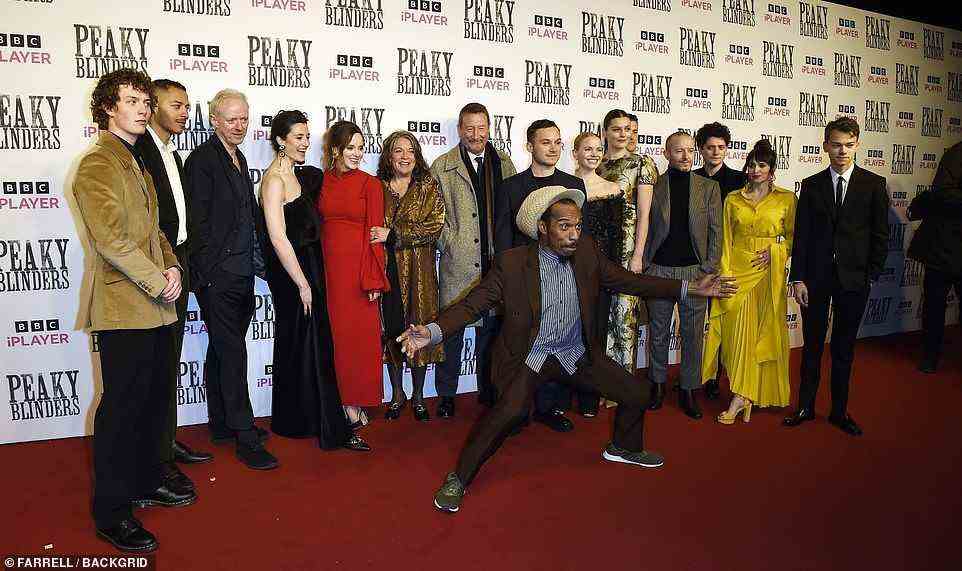 Centre of attention: Benjamin Zephaniah leapt in front of the cast as they posed for a group photo