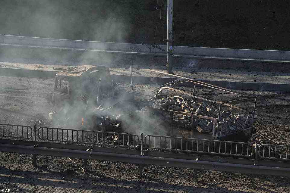 Debris of a burning military truck is seen on a street in Kyiv, Ukraine on Saturday morning as Russian troops stormed towards the capital