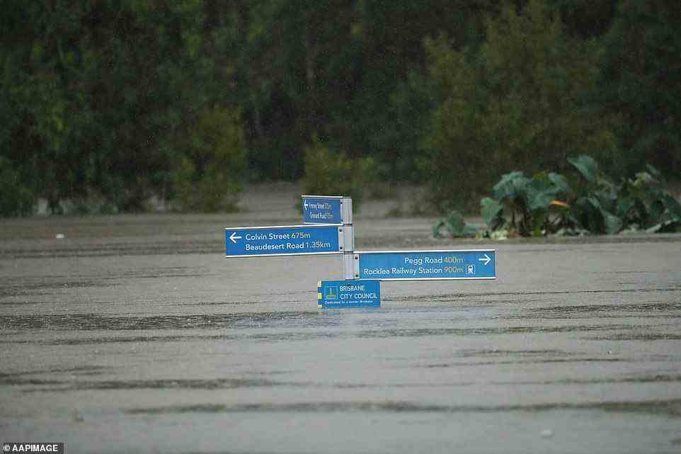 A street sign in Southside is almost completely submerged under rising floodwaters