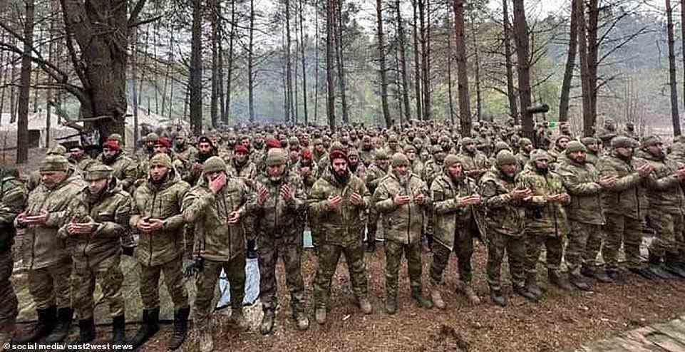 A group of Chechen rebel fighters is pictured in a Ukrainian forest - but huge numbers of the soldiers have since been wiped out after Ukrainian soldiers blew up 56 of their tanks