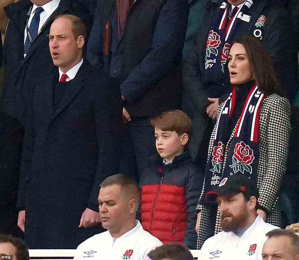 The eight-year-old (pictured centre) appeared in great spirits as he stood in the stands alongside his parents, dressed in a red and navy jacket, while his mother Kate, 40, oozed elegance in a houndstooth £449 Knightsbridge Coat from Holland Cooper, and his father Prince William, 39, appeared dapper in a red tie and black jumper combo
