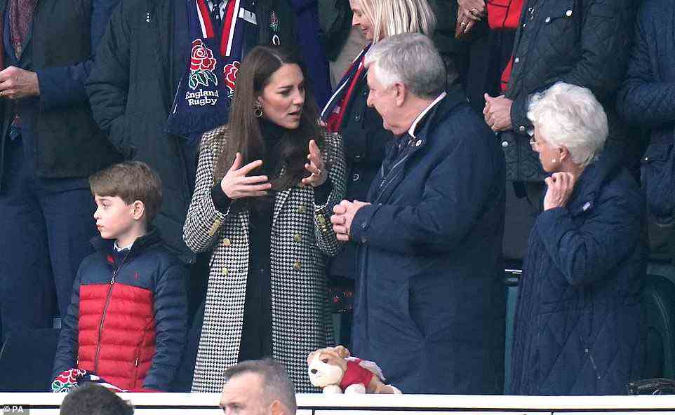George, who has previously attended football matches with the Duke and Duchess of Cambridge, stood between his parents for the game