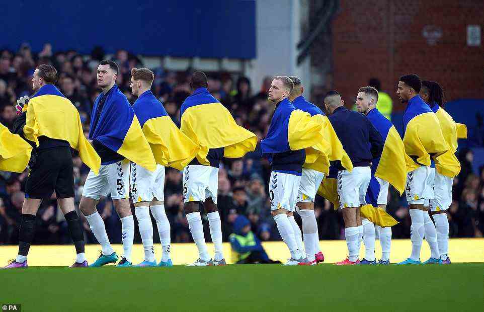 Everton's players had Ukrainian flags draped over their shoulders as they lined up for the game