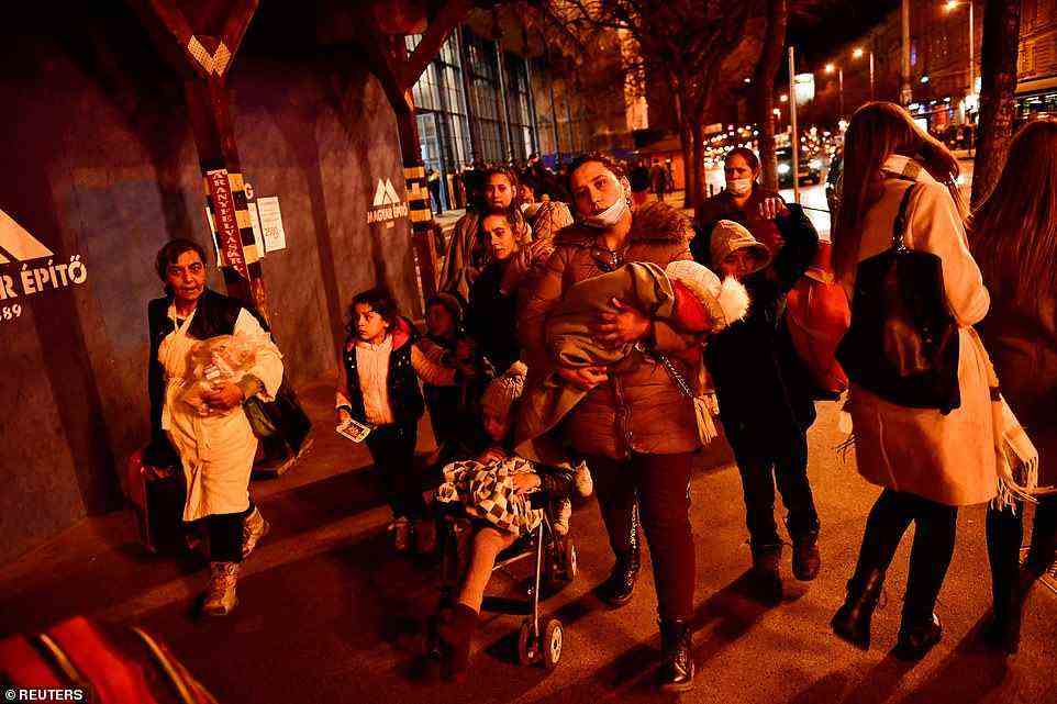 Mothers fleeing with their children from Ukraine stand at Nyugati station, after Russia launched a massive military operation against Ukraine, in Budapest, Hungary