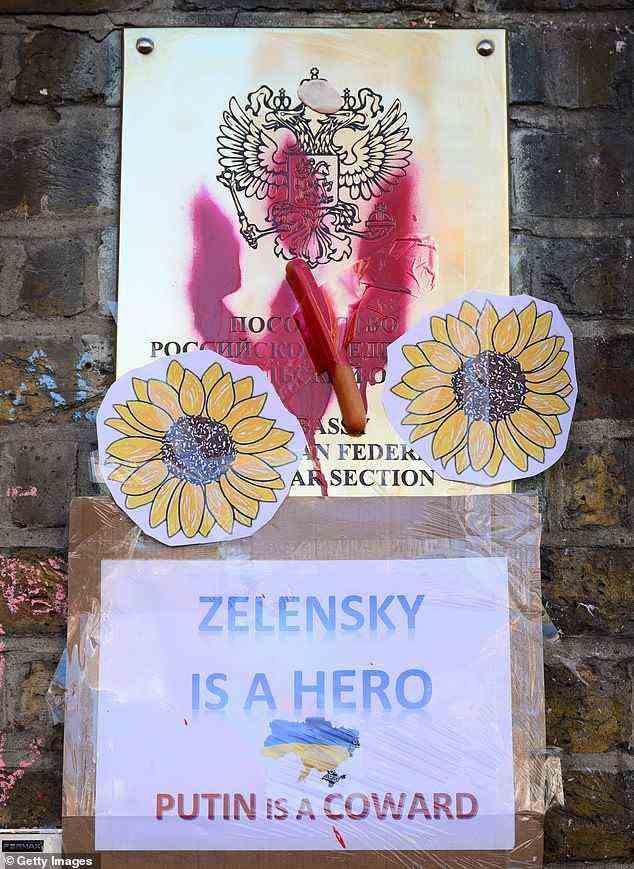 The sunflower emblem of Ukrainian resistance is seen on the walls of the Russian embassy