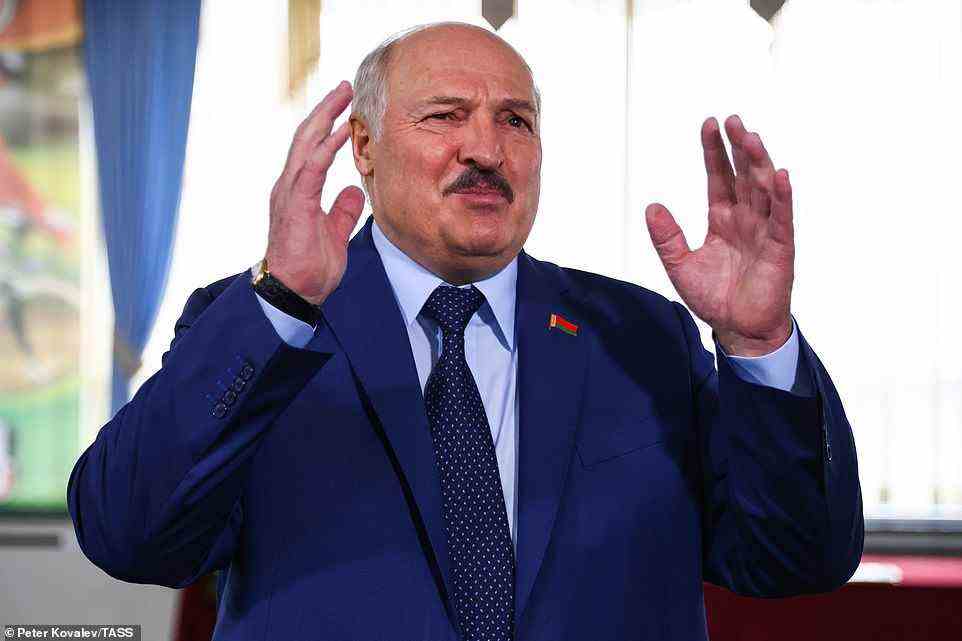Belarusian dictator Alexander Lukashenko talks to reporters at a polling station after casting his vote in the 2022 Belarusian constitutional referendum, Sunday, February 27, 2022