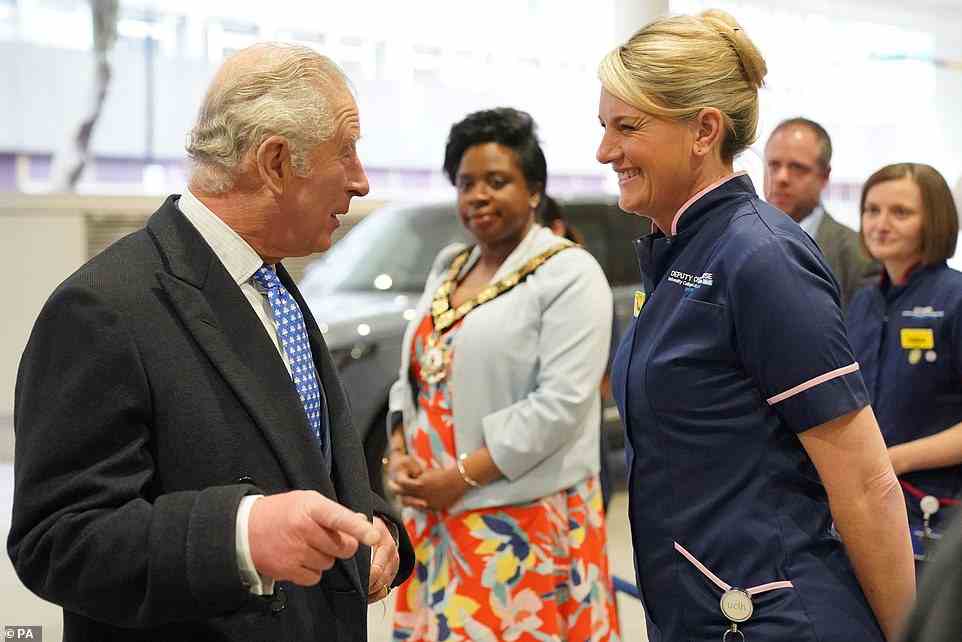 Mostly wearing a mask when walking around the hospital, Prince Charles (left) spoke to hospital staff and unveiled a plaque to recognise the opening.