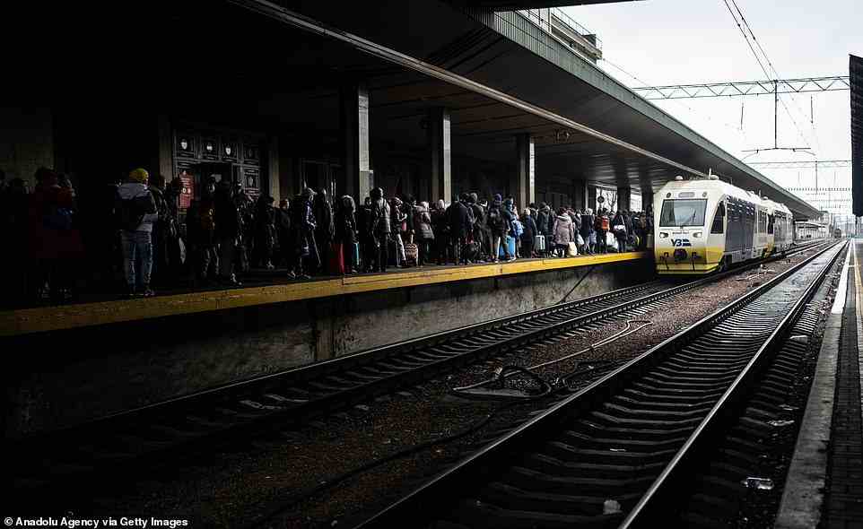Civilians are seen at the train station attempting to head west from Kyiv on Wednesday, before the building was hit