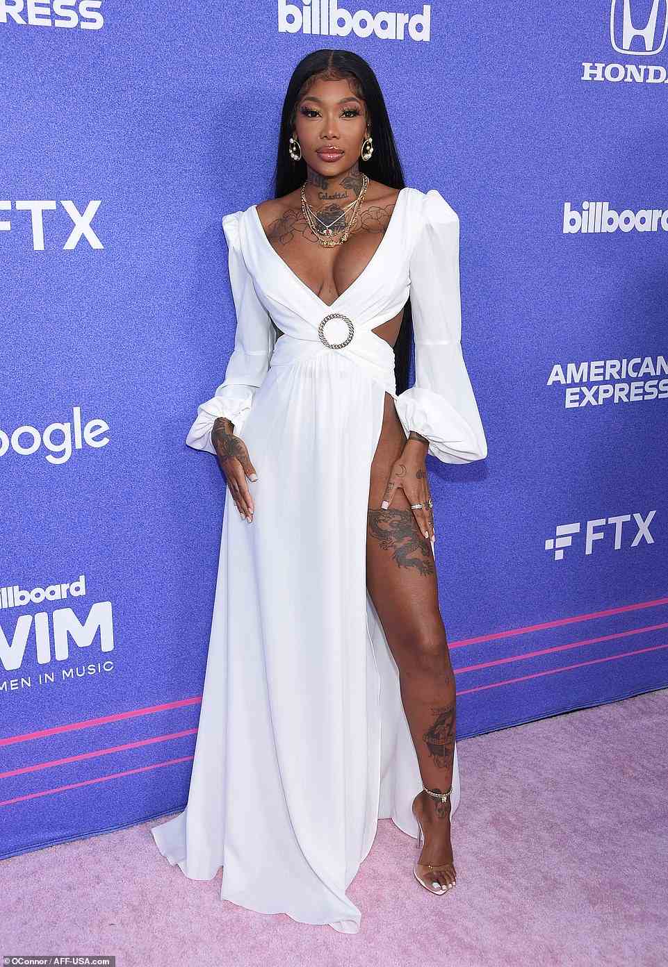Ethereal: Summer Walker slipped into a sexy puff-sleeved gown with a hip-high slit up one leg and a criss-cross bodice that gave a glimpse at her toned abdominals
