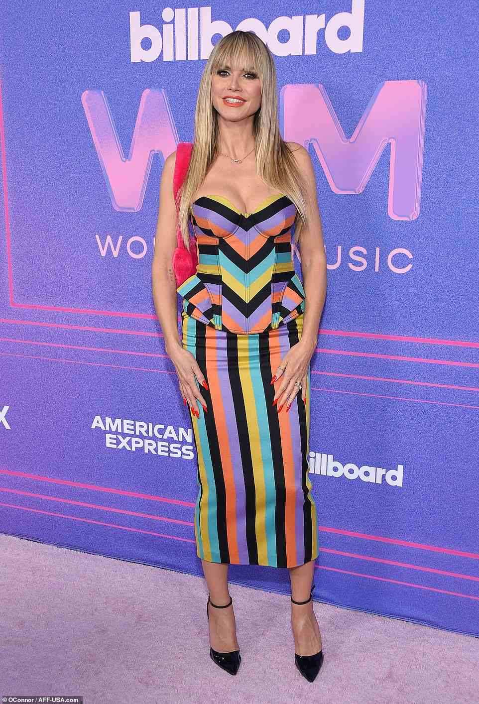 Quirky: Heidi Klum highlighted her slender frame in a colorful striped strapless dress with a quirky peplum.