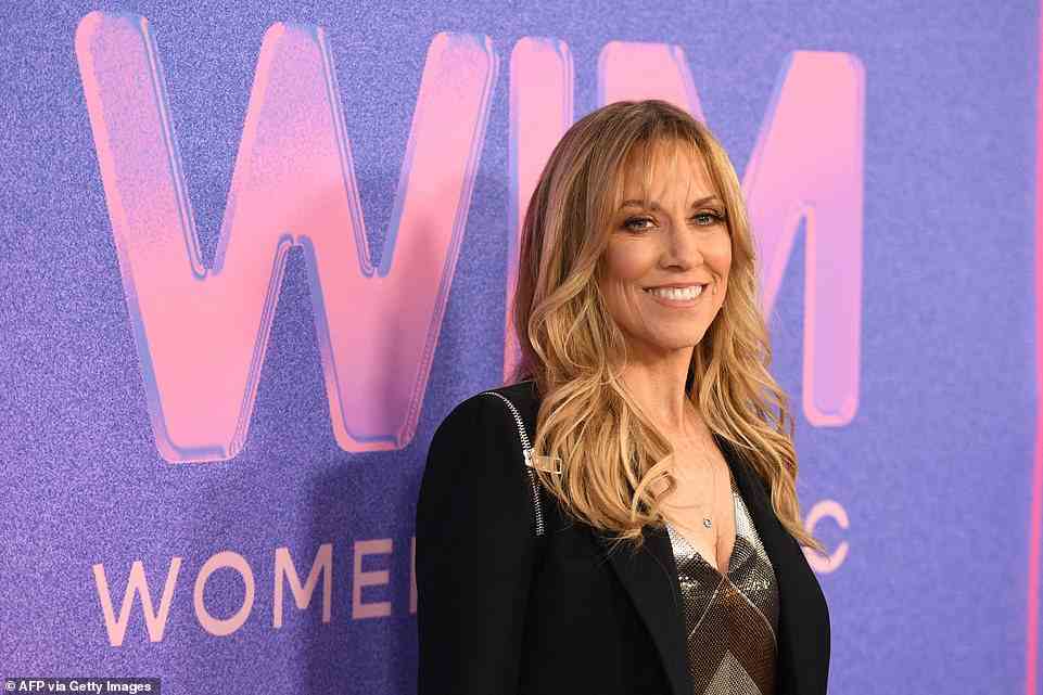 Flawless: Sheryl Crow flashed her flawless smile while striking poses in a black blazer and a metallic top