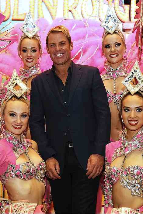 The Australian cricket champion poses backstage with the Moulin Rouge Australian dancers at Le Moulin Rouge on June 27, 2014 in Paris