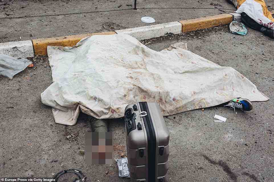 person, who was trying to flee with his family, lies on the ground after the shelling of the Russian army at the evacuation point of Irpin, several members of the same family have been killed in this attack today