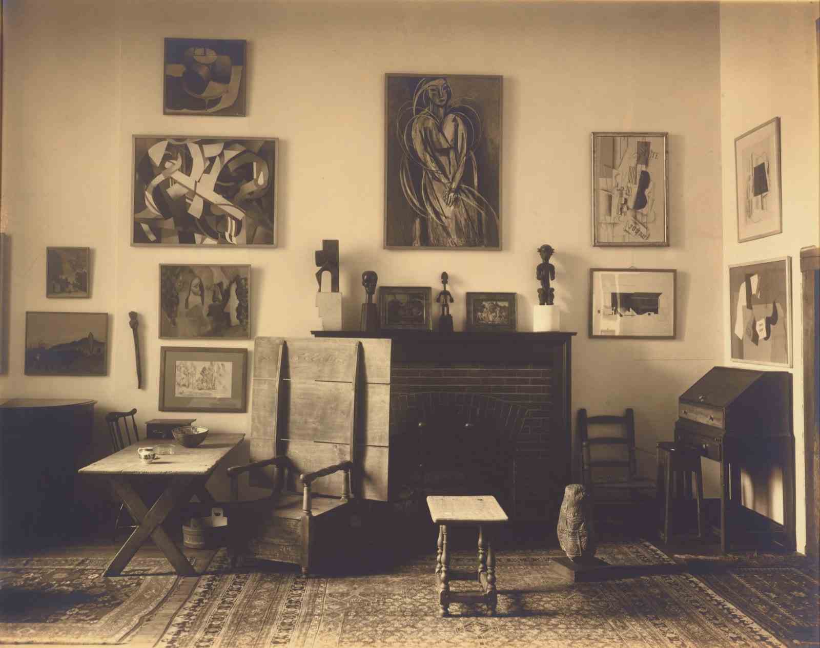A room filled with wooden furniture and paintings hung on the walls.