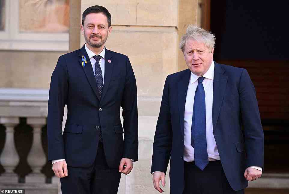 Prime Minister Boris Johnson poses with Slovakia's Prime Minister Eduard Heger today in London ahead of a meeting of the V4 group of nations