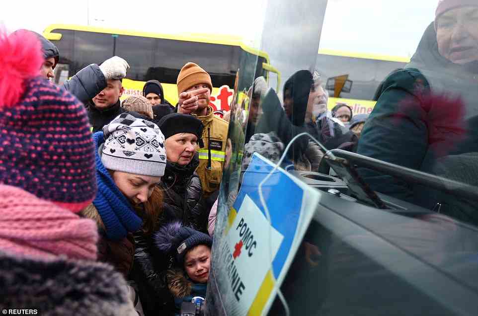The UK Government is facing mounting criticism over its visa scheme for Ukrainian refugees. People are pictured today boarding a bus to Warsaw in Przemysl, Poland