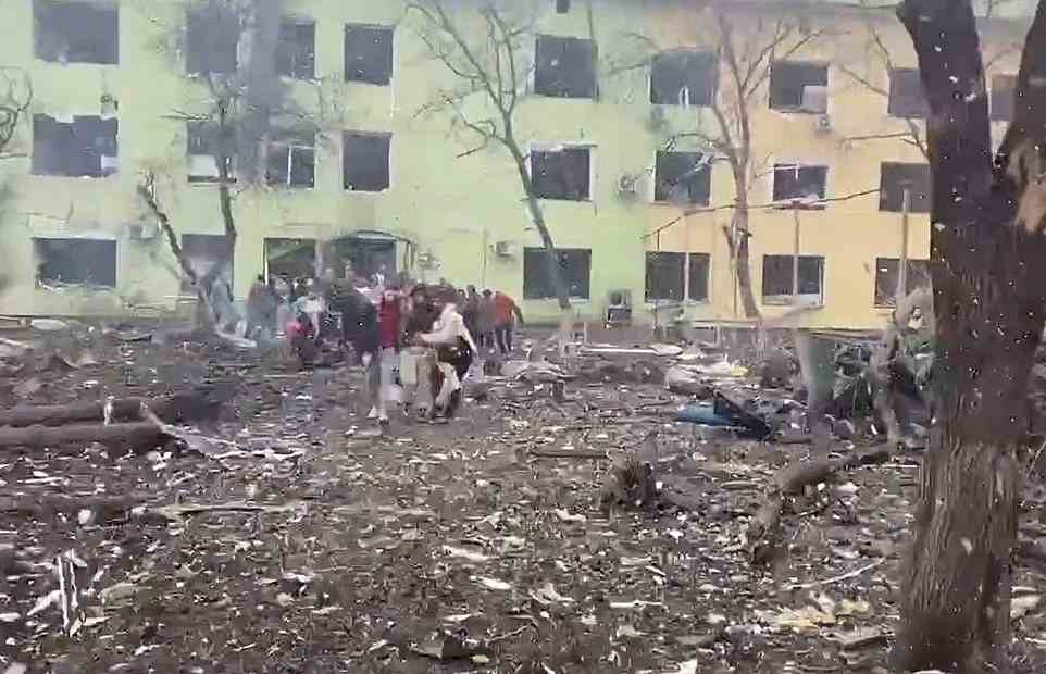 Wounded families and patients evacuate from a badly-damaged building at the hospital. Local officials said the damage was 'colossal' and were not able to give an immediate number on the injured and dead