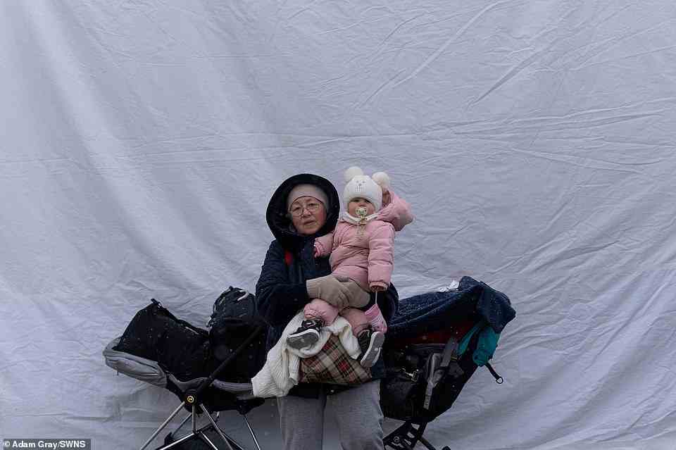 Olya and her granddaughter Polina, from Kiev, Ukraine, stand by a tent as Ukrainian refugees cross the border