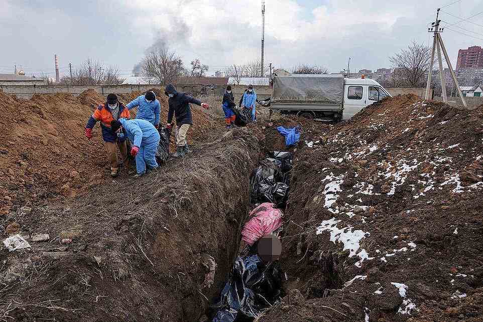 Graphic images show mortuary workers digging trenches 25m long at one of the old cemeteries in the besieged port city of Mariupol, and making the sign of the cross as they pushed dead bodies wrapped in carpet or bags over the edge